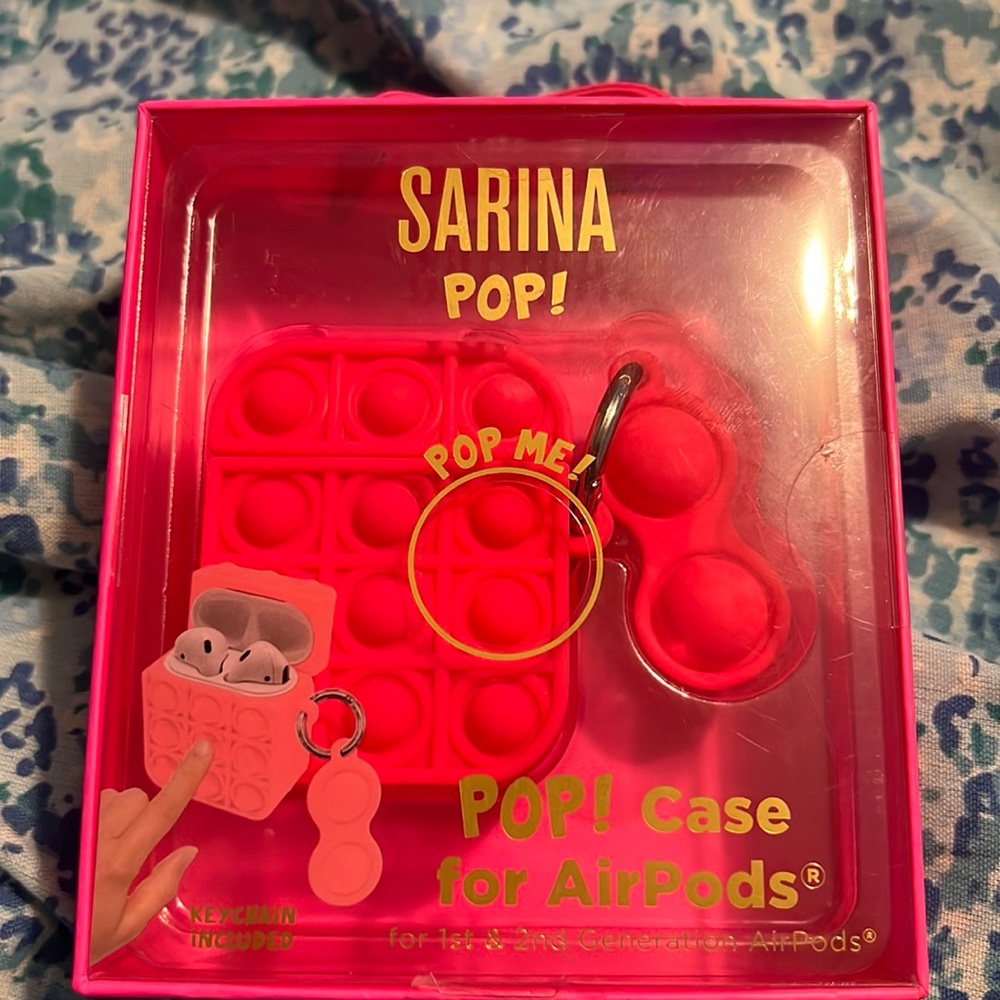 It’s a pop it AirPod case and the color is pink with a keychain on it